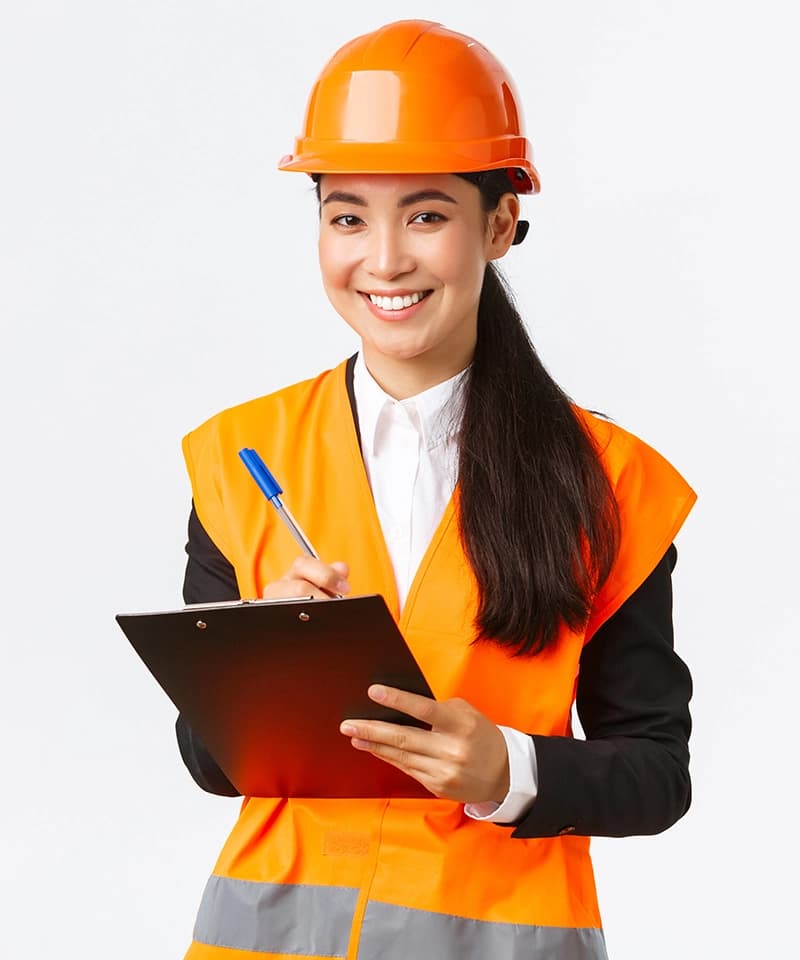Professional construction worker in orange hard hat and safety vest holding clipboard